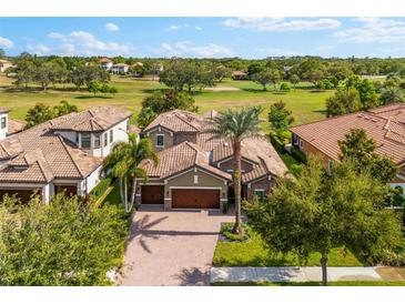 Beautiful single-Gathering home boasts a lush landscaped yard, tile roof, and a spacious driveway at 1416 Via Verdi Dr, Palm Harbor, FL 34683