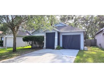 Charming single-Gathering home with a two-car garage and well-maintained landscaping, offers curb appeal and convenience at 15124 Deer Meadow Dr, Lutz, FL 33559