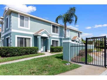 Inviting two-story townhouse featuring a private entrance, manicured lawn, and secure gated entry at 1603 Fluorshire Dr, Brandon, FL 33511