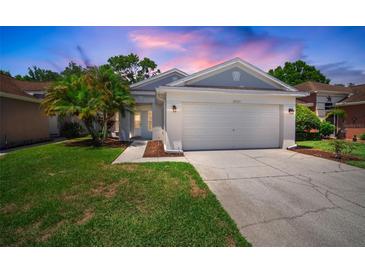 Charming single-Gathering home featuring a well-maintained lawn, two-car garage and inviting curb appeal at 26501 Whirlaway Ter, Wesley Chapel, FL 33544