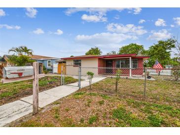 Charming single-story home featuring a fenced yard and a welcoming walkway to the front entrance at 3324 W Saint Joseph St, Tampa, FL 33607