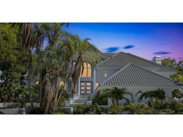 Stunning two-story home featuring an arched entry and lush tropical landscaping at 5212 62Nd S Ave, St Petersburg, FL 33715