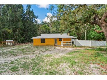 Charming one-story home featuring a fenced yard and inviting front porch at 8828 Jasmine Blvd, Port Richey, FL 34668