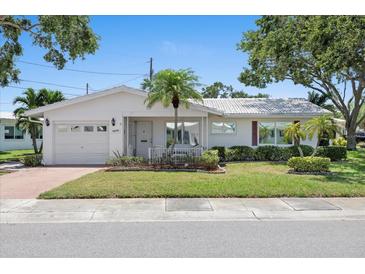 Charming single-story home with well-manicured lawn, front porch, and attached garage at 9690 41St N St # 0, Pinellas Park, FL 33782