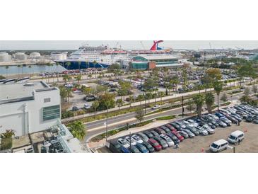 Aerial view of harbor featuring cruise ships docked near the terminal and sprawling parking lots at 101 N 12Th St # 400, Tampa, FL 33602