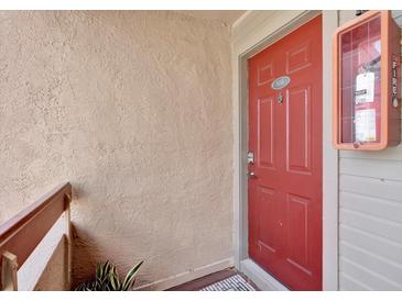 Inviting unit entrance with a red front door and a visible unit number at 10265 Gandy N Blvd # 906, St Petersburg, FL 33702