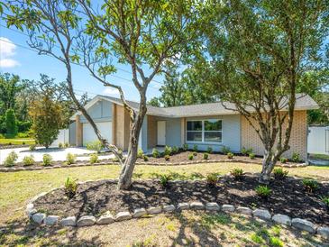 Charming single-story home with fresh landscaping, inviting curb appeal, and a well-manicured front yard at 2433 Blind Pond Ave, Lutz, FL 33549
