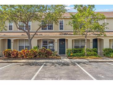 Charming townhome with lush landscaping, a beautiful front door wreath, and reserved parking spaces at 4734 67Th N Ave, Pinellas Park, FL 33781