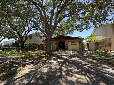 Charming single-Gathering home featuring stone accents, mature shade trees, and a driveway for convenient parking at 484 Itasca Ave, Tampa, FL 33606