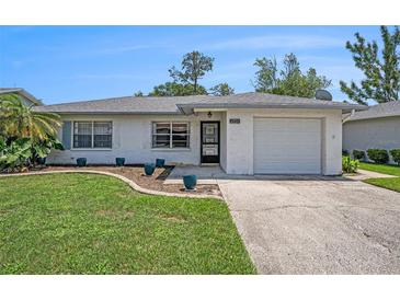 Charming single-story home with well-manicured lawn and attached one car garage at 6520 Meadowbrook Ln, New Port Richey, FL 34653