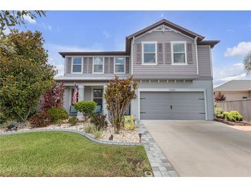 Charming two-story home featuring a landscaped front yard and neutral gray exterior at 11684 Brighton Knoll Loop, Riverview, FL 33579