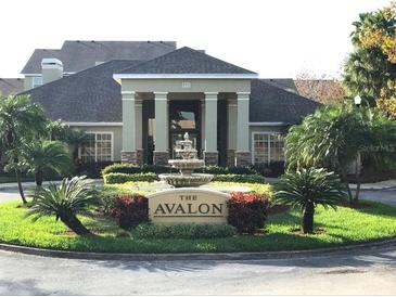 Welcoming condo building entrance with a fountain and lush tropical landscaping at 1230 S Missouri Ave # 704, Clearwater, FL 33756