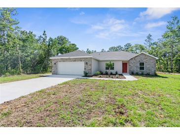 Charming single-story home featuring stone accents, fresh landscaping and a two-car garage at 16247 Little Auk Rd, Weeki Wachee, FL 34614