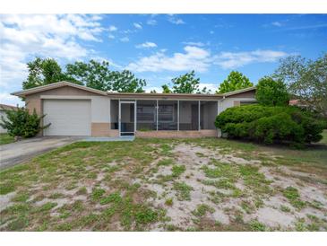 Charming single-story home with a screened-in porch and attached one car garage at 3547 Odom Dr, New Port Richey, FL 34652