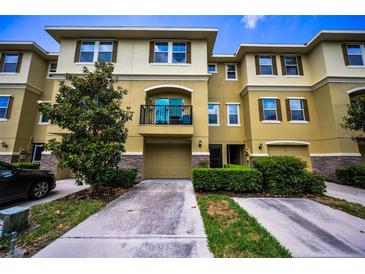 Beautiful multi-story townhome with a front-loading garage and a cozy second-story balcony at 5529 White Marlin Ct, New Port Richey, FL 34652