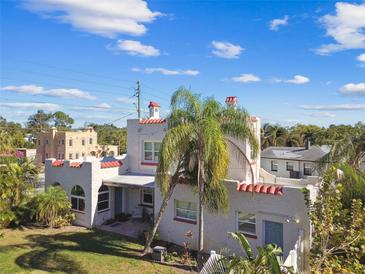 Stunning stucco home with a red tile roof, chimney, and mature landscaping at 1020 38Th N Ave, St Petersburg, FL 33704