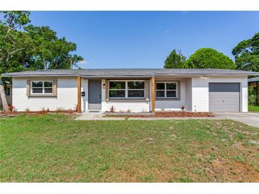 Charming one story home featuring a covered entry and an attached one car garage at 7500 16Th N St, St Petersburg, FL 33702