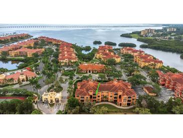Beautiful aerial view of a waterfront condo community with lush landscaping and stunning water views at 2705 Via Murano # 127, Clearwater, FL 33764