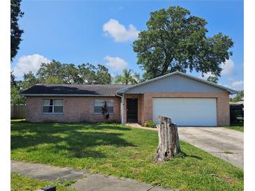 Charming brick home with a well-maintained lawn and mature tree at 603 Southwood Cv, Brandon, FL 33511