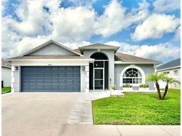 Charming single Gathering home with a two-car garage, front yard, and well-maintained landscaping at 10811 Lakeside Vista Dr, Riverview, FL 33569