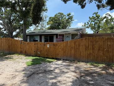 Charming single-story home featuring a fenced yard with mature trees providing shade and privacy at 440 53Rd N St, St Petersburg, FL 33710