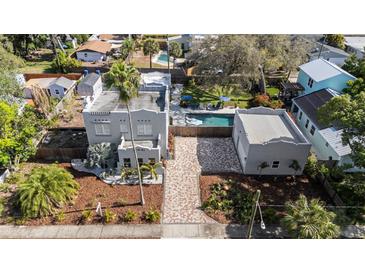 Aerial view of a beautifully landscaped home with a pool and detached garage at 6251 4Th S Ave, St Petersburg, FL 33707