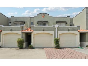 Charming townhouse with a two-car garage, elegant tile roof, and nicely manicured landscaping at 2914 W Gandy Blvd # C, Tampa, FL 33611