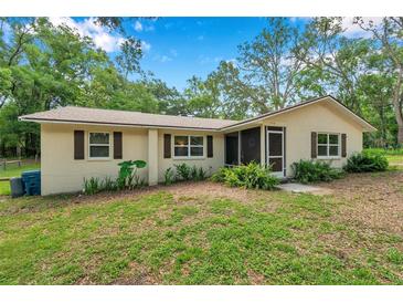 Charming single-story home with a well-maintained lawn and cozy shutters at 316 Jenkins Ave, Brooksville, FL 34604
