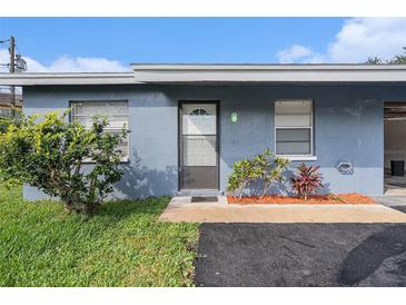 Charming exterior view with a freshly painted blue exterior and well-maintained landscaping at 3404 Dahlia Pl, Largo, FL 33771