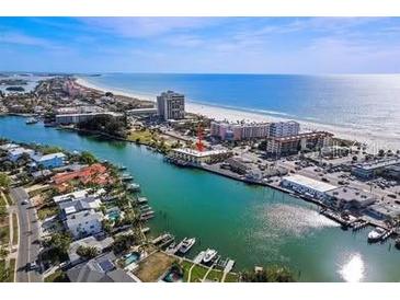 Beautiful aerial view of the beach, water, and condos with ample parking and canals nearby at 4103 Gulf Blvd # 210, St Pete Beach, FL 33706