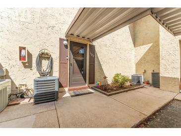 Inviting front entrance with covered porch and well-maintained landscaping for a welcoming arrival at 501 E Bay Dr # 102, Largo, FL 33770