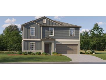 Charming two-story home featuring a well-manicured lawn, gray siding, and an attached two-car garage at 8064 Painted Sky Pl, Land O Lakes, FL 34637