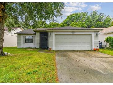 Charming one-story home with a well-maintained lawn and attached two car garage at 10811 Candlin Ct, Riverview, FL 33578