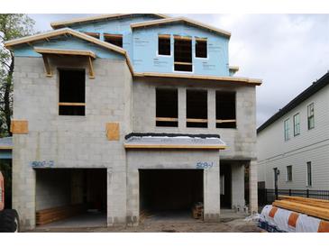 Exterior view of a new construction home showing the frame of the facade and two-car garage at 503 W Warren Ave # 1, Tampa, FL 33624