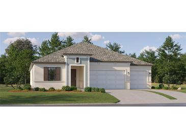 Charming one-story home with a two-car garage, well-manicured lawn and inviting front entryway at 9565 Runaway Breeze Dr, Land O Lakes, FL 34637