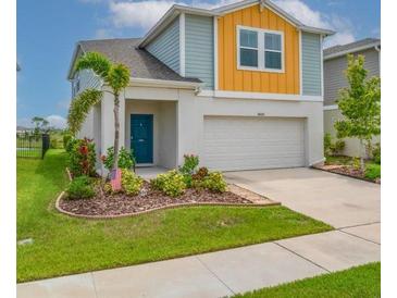 Charming two-story home with colorful accents, well-maintained landscaping, and attached two-car garage at 14643 Brumby Ridge Ave, Lithia, FL 33547