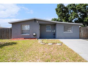 Charming single-story home features a well-maintained front yard and neutral gray exterior at 4521 W North St, Tampa, FL 33614