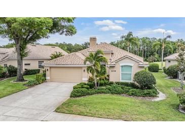 Charming single-story home featuring a tile roof, meticulously manicured landscaping, and a two-car garage at 5156 Pinnacle Dr, Oldsmar, FL 34677