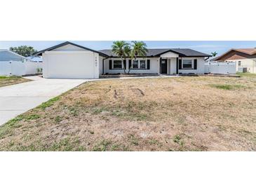 Charming one-story home featuring a modern exterior and two palm trees in the front yard at 7607 22Nd W Ave, Bradenton, FL 34209