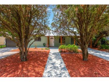 Charming home with a well-manicured front yard and inviting entryway at 2303 E Osborne Ave, Tampa, FL 33610