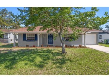 Charming single-story home with a well-manicured front yard and beautiful curb appeal at 2613 E 113Th Ave, Tampa, FL 33612