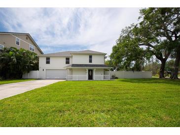 Charming white two-story home with a spacious front yard and attached two car garage at 2807 57Th S St, Gulfport, FL 33707