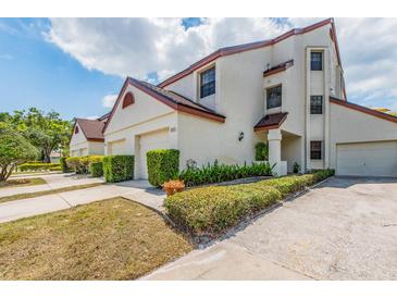 Charming townhouse with manicured landscaping and a private garage, bathed in natural light at 3455 Countryside Blvd # 101, Clearwater, FL 33761