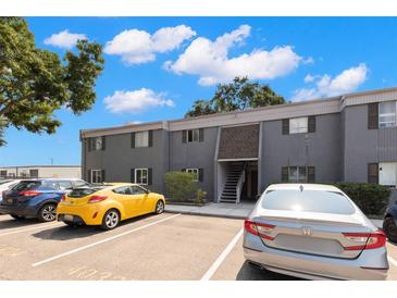 Well-maintained, gray two-story condo with ample parking spaces available for residents and visitors at 4032 Cortez Dr # A, Tampa, FL 33614