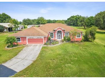 Charming single-story home boasting an attached garage and lush lawn at 5100 Lockhart Rd, Brooksville, FL 34602
