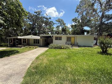 Quaint single story home featuring a well-maintained yard and a covered entrance at 708 Keeling St, Brooksville, FL 34601
