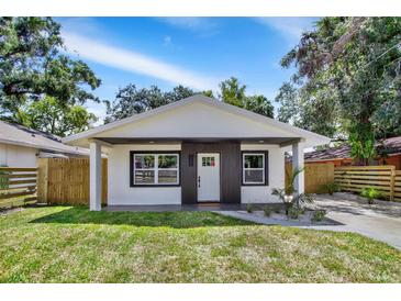 Charming single-story home with a well-manicured lawn, complemented by a newly painted exterior at 8603 N 9Th St, Tampa, FL 33604