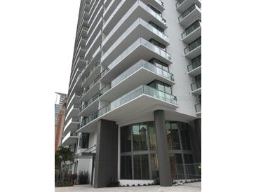 Upscale high-rise building featuring large windows and glass-railed balconies for each unit at 100 1St N Ave # 702, St Petersburg, FL 33701
