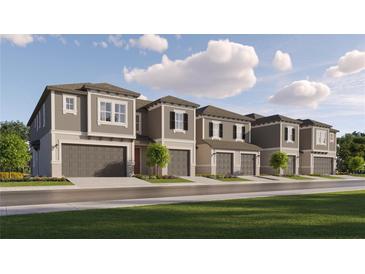 Charming townhome exteriors with attached garages, landscaped yards, and inviting curb appeal at 10812 Keato Beach Ct, Tampa, FL 33647