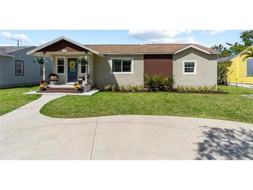 Charming single-story home with a well-manicured lawn, beautiful landscaping, and a welcoming front porch at 715 39Th Ne Ave, St Petersburg, FL 33703